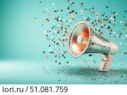 A dazzling megaphone, encrusted with sequins, gleams in shades of rose gold and platinum. Set against a bold turquoise background, this stylish accessory commands attention and exudes glamour. Стоковое AI-изображение, AI-художник Nart / Фотобанк Лори