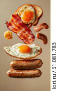 A surreal English breakfast levitation shot features floating eggs, bacon, and toast. This gravity-defying composition highlights the artistry and creativity of culinary presentation. Стоковое AI-изображение, AI-художник Nart / Фотобанк Лори