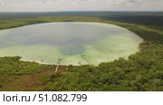 Circular lagoon lake cenote with wooden piers and swimmers in Tulum, Mexico. Стоковое видео, видеограф Ольга Сухарева / Фотобанк Лори