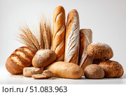 Assortment of Baked bread. Loaf of Bread. Fresh Bakery Products. Healthy Food Concept. Top View. Homemade Sourdough Bread Variety with Flour on a White Background. Wheat Spikes. Close Up. Advertising. Стоковое AI-изображение, AI-художник Марина Демидюк / Фотобанк Лори