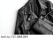 Black leather jacket with zippers and pockets and black leather stylish bag. Modern outerwear. Close-up. Fashion background. Autumn urban street clothes. Fashionable concept. Women's casual day outfit. Стоковое AI-изображение, AI-художник Марина Демидюк / Фотобанк Лори