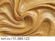 Creamy peanut butter spread swirl surface. Closeup, full frame. Crunchy Peanut butter background. American cuisine traditional product. Appetizing textured smears. Food paste from ground roasted nuts. Стоковое AI-изображение, AI-художник Марина Демидюк / Фотобанк Лори