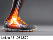 Leg with ankle joint pain icon. Foot wearing running shoes showing the bones in the ankle area. Grey floor. Feet with red effect of painful injury problems. Legs with anatomical detail glowing orange. Стоковое AI-изображение, AI-художник Марина Демидюк / Фотобанк Лори