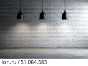 Modern black pendant lights with vintage light bulb hanging among bricks wall. Hanging ceiling light in a white shared office space. Decorative geometric metal lamp. Suspended chandelier loft style. Стоковое AI-изображение, AI-художник Марина Демидюк / Фотобанк Лори