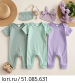 Set for a newborn girl. Three cotton overalls. Lilac, mint, pleasant delicate colors. Стоковое AI-изображение, AI-художник Ирина Гильмуллина / Фотобанк Лори