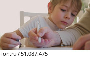 Dad teaches his son writing and counting. Kids primary education. Children learn, study in home school. Daddy male helping teaching little child boy support studying, learning homework. Knowledge day. Стоковое видео, видеограф Марина Демидюк / Фотобанк Лори