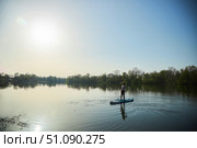 A woman swims on a sapboard on the lake. Water entertainment. Стоковое фото, фотограф Наталия Кирсанова / Фотобанк Лори