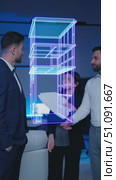 A Professional Engages with a Futuristic 3D Model of a Building Using Augmented Reality Technology to Explore Architectural Innovations and Design Concepts. Стоковое AI-видео, аниматор Владимир Федоров / Фотобанк Лори