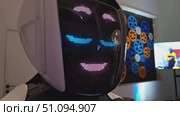Futuristic robot displaying animated led expressions in a modern tech environment. Стоковое видео, видеограф Zakharova Natasha / Фотобанк Лори