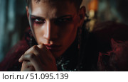 Mysterious elf character in a dark fantasy setting with intense gaze and striking features. Стоковое AI-изображение, AI-художник Ксения Лаптева / Фотобанк Лори