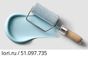 Painting tool and blue paint swirl creating a fresh home decor touch. Стоковое AI-изображение, AI-художник Katsiaryna Repich / Фотобанк Лори