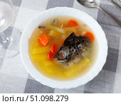 Salmon offal soup with potatoes, carrots and parsley closeup. Стоковое фото, фотограф Яков Филимонов / Фотобанк Лори