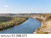 Top view of natural landmark - White Rocks along the bank of Siberian River Belaya River near village of Kholmushino, Usolye-Sibirskoye district. Beautiful summer landscape with small village below by river. Стоковое фото, фотограф Виктория Катьянова / Фотобанк Лори