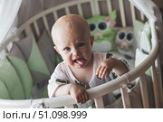 Little Rascal Shows Tongue in His Crib, Getting Ready to Enjoy a New Day. Стоковое фото, фотограф Aleksandr Golubev / Фотобанк Лори