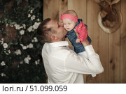 Cherishing Those First Years, Father Gently Kisses Baby Daughter. Стоковое фото, фотограф Aleksandr Golubev / Фотобанк Лори