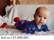 Discoveries Abound for Inquisitive Babe on Fluffy White Blanket. Стоковое фото, фотограф Aleksandr Golubev / Фотобанк Лори
