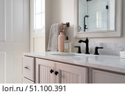 Grey bathroom vanity with white walls, mirror and marble countertop, black hardware. Clean aesthetic background. Home interior room design. Gray cabinet in a bathroom. Стоковое AI-изображение, AI-художник Марина Демидюк / Фотобанк Лори