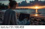 A woman is sitting on the beach with a laptop open in front of her. Стоковое AI-изображение, AI-художник Ярославский Максим / Фотобанк Лори