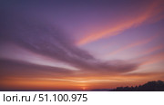 A stunning sunset over the ocean, with vibrant colors and wispy clouds, creates a beautiful scene. Стоковое AI-изображение, AI-художник Лариса Пономарева / Фотобанк Лори