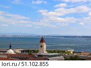 The view of the city from view point on a sunny summer day. The roofs of the houses and the river Tagus. Lisbon, Portugal. Стоковое фото, фотограф Вера Федорова / Фотобанк Лори
