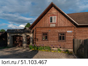 Izborsk, Pskov Region, Russia, June 9, 2024: The Blinnaya Cafe Museum in a traditional Russian wooden log house on a sunny summer day. Редакционное фото, фотограф Ula Ulachka / Фотобанк Лори