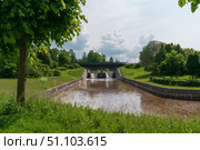 Strelna, St. Petersburg, Russia, June 12, 2025: The bridge over Kikenka River on the territory of the Palace and Park Ensemble of the Konstantinovsky Palace on a sunny summer day. Редакционное фото, фотограф Ula Ulachka / Фотобанк Лори