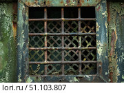 Rusty metal grid covering opening in decaying wall. Стоковое AI-изображение, AI-художник Иван Рябоконь / Фотобанк Лори