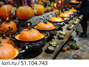 Chef preparing tasty pumpkin soup for halloween party in a medieval tavern. Стоковое AI-изображение, AI-художник Иван Рябоконь / Фотобанк Лори