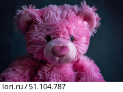 Pink fluffy teddy bear posing on dark background. Стоковое AI-изображение, AI-художник Иван Рябоконь / Фотобанк Лори