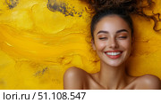 Captivating close-up of serene young woman with eyes closed and genuine, radiant smile, against dynamic, textured golden yellow backdrop. Стоковое AI-изображение, AI-художник Данила Большаков / Фотобанк Лори