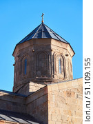 Stepantsminda, Georgia - January 03, 2023: Gergeti Church of the 14th century at the foot of Mount Kazbek. Редакционное фото, фотограф Наталия Кирсанова / Фотобанк Лори