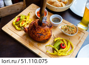 Popular dish of Austrian cuisine is roasted pork knuckle in beer sauce. Стоковое фото, фотограф Яков Филимонов / Фотобанк Лори