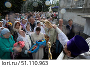 Священник кропит святой водой прихожан в праздник Яблочный спас. Редакционное фото, фотограф Дмитрий Неумоин / Фотобанк Лори