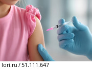 Child receiving a vaccination. Little boy in face mask in doctor's office is vaccinated. Kid giving injection shot. Syringe with covid-19, coronavirus, flu vaccine. Dangerous infectious disease, MPOX. Стоковое AI-изображение, AI-художник Марина Демидюк / Фотобанк Лори
