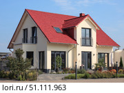 House Exterior. Roof Window. Second floor among blue sky. Mansard attic. Newly build houses. Gable roof with skylight, asphalt roofing, shingles. Residential Home. Vinyl Siding. Polymeric roof-tiles. Стоковое AI-изображение, AI-художник Марина Демидюк / Фотобанк Лори