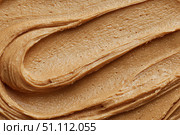 Creamy peanut butter spread swirl surface. Closeup, full frame. Crunchy Peanut butter background. American cuisine traditional product. Appetizing textured smears. Food paste from ground roasted nuts. Стоковое AI-изображение, AI-художник Марина Демидюк / Фотобанк Лори