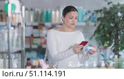 Asian woman scans mobile barcode of ointment for mobile app payment. Стоковое видео, видеограф Яков Филимонов / Фотобанк Лори