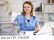 Portrait of female doctor who is working with laptop and documents. Стоковое фото, фотограф Яков Филимонов / Фотобанк Лори