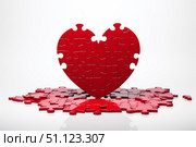 Red heart puzzle forming a bigger puzzle on white background. Стоковое AI-изображение, AI-художник Иван Рябоконь / Фотобанк Лори
