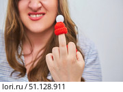 A woman with warm hats on each finger. An indecent hand gesture. The arrival of the cold season, insulation. Resistance to cold and winter season. Стоковое фото, фотограф Наталия Кирсанова / Фотобанк Лори
