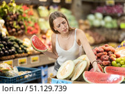 Woman near vegetable stand in store choose watermelon. Стоковое фото, фотограф Яков Филимонов / Фотобанк Лори