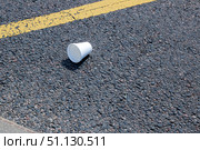 A Disposable Cup Carelessly Littered on the Asphalt Pavement. Стоковое фото, фотограф Аксенова Вера / Фотобанк Лори