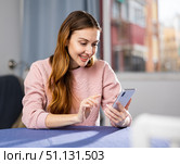 Young woman is texting with someone on a mobile phone. Стоковое фото, фотограф Яков Филимонов / Фотобанк Лори