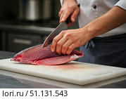 Blue Marlin Swordfish being expertly filleted by a chef in a modern kitchen environment. Стоковое AI-изображение, AI-художник Гайфуллина Дина / Фотобанк Лори