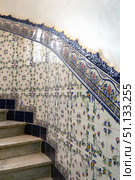 Spiral staircase. Top view. Chandelier and ceramic tiles on the wall. Стоковое фото, фотограф Евгений Ткачёв / Фотобанк Лори