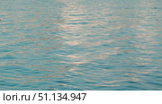 Serene ripples on the water reflecting soft light colors. Soft waves evoke a sense of calm and tranquility. A calm morning or late evening by a quiet lake or sea. Стоковое видео, видеограф Воловодов Владимир / Фотобанк Лори