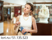 Thoughtful woman examining historacal exhibits in museum. Стоковое фото, фотограф Яков Филимонов / Фотобанк Лори