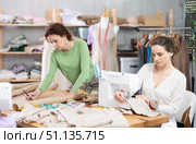 Two clothing makers working on pattern and stitching. Стоковое фото, фотограф Яков Филимонов / Фотобанк Лори