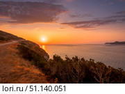 Sunrise on the island of Crete near Spinalonga with sea coast, rocks and dirt road. (2019 год). Стоковое фото, фотограф Емельянов Евгений Викторович / Фотобанк Лори