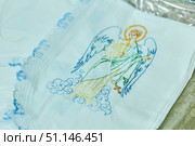 Krasnodar, Russia. July 17, 2022: An embroidered icon on a baptismal garment for a baby. The art of embroidery. Редакционное фото, фотограф Наталия Кирсанова / Фотобанк Лори